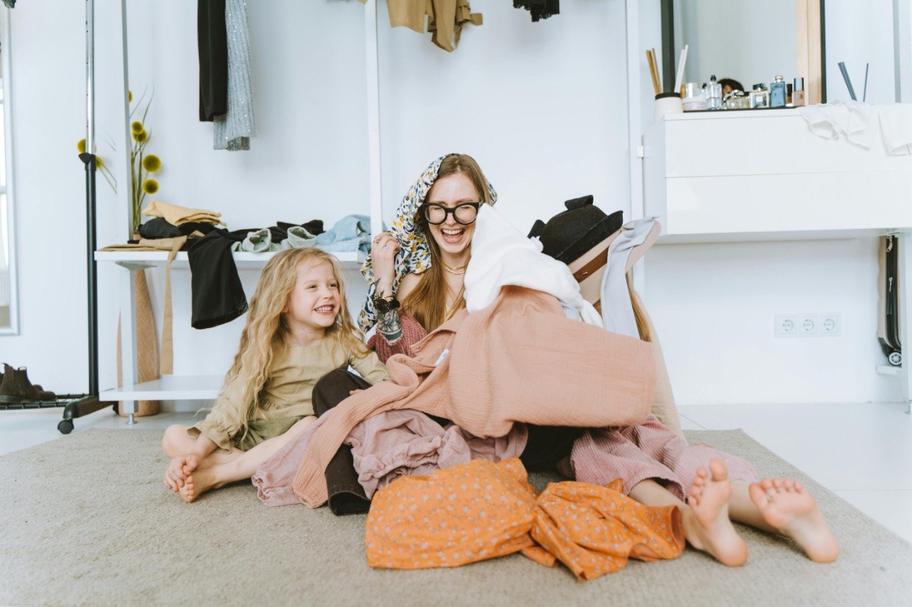 Mother and daughter sorting through clothes together